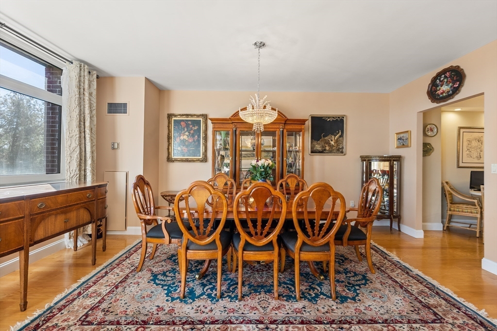 79 Florence Street, Unit 508S Newton, MA 02467 - Photo 6 of 20 a view of a dining room with furniture window and wooden floor
