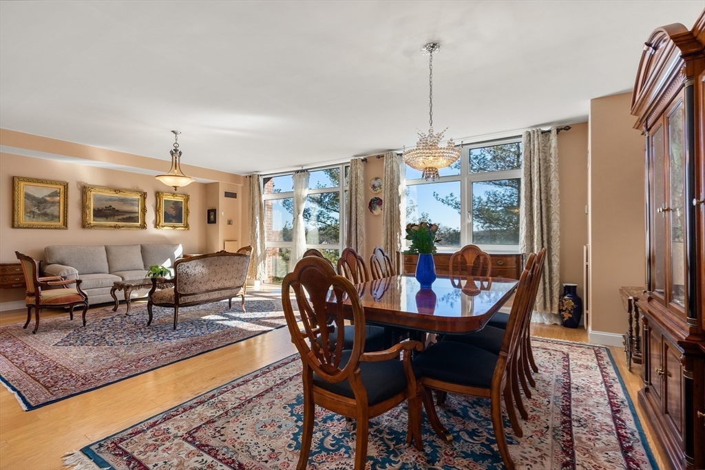 79 Florence Street, Unit 508S Newton, MA 02467 - Photo 7 of 20 a dining room with furniture a chandelier and wooden floor
