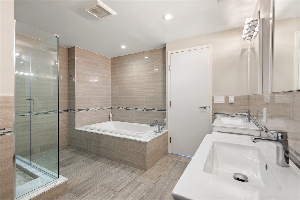 79 Florence Street, Unit 508S Newton, MA 02467 - Photo 9 of 20 a bathroom with a sink and a large mirror