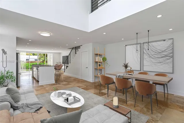 a living room with furniture kitchen view and a table
