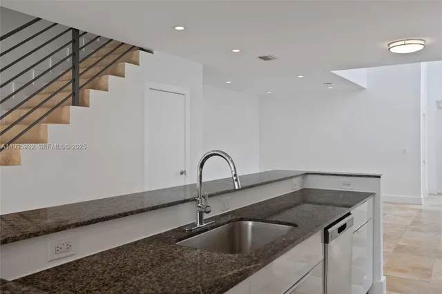 a kitchen with a sink and cabinets