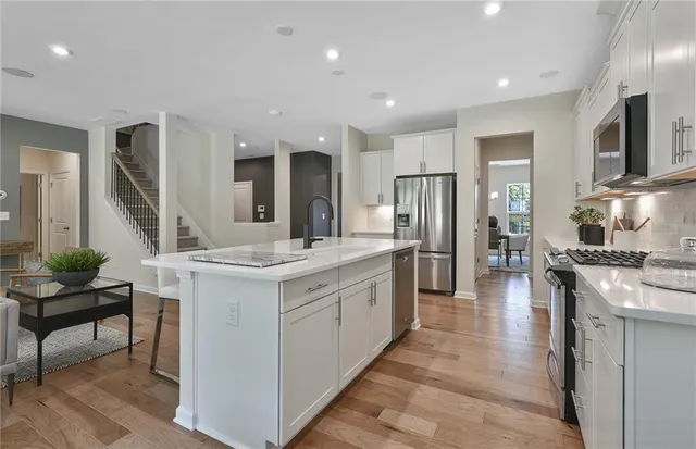 a kitchen with white cabinets and white appliances