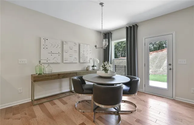a dining room with furniture a fireplace kitchen view and a flat screen tv