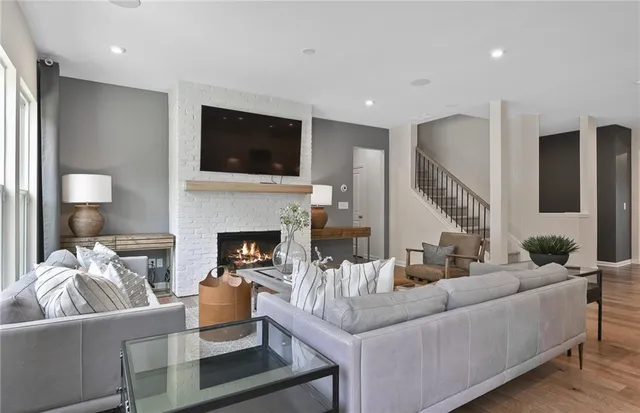 a living room with furniture fireplace and a flat screen tv