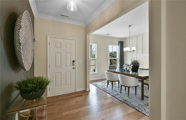 a view of a hallway with wooden floor and staircase
