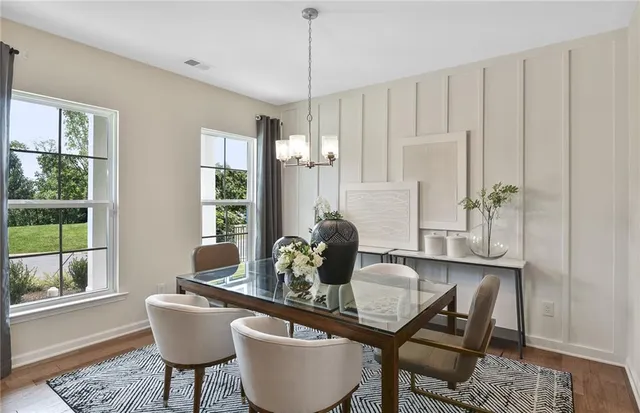 a view of a dining room with furniture and chandelier