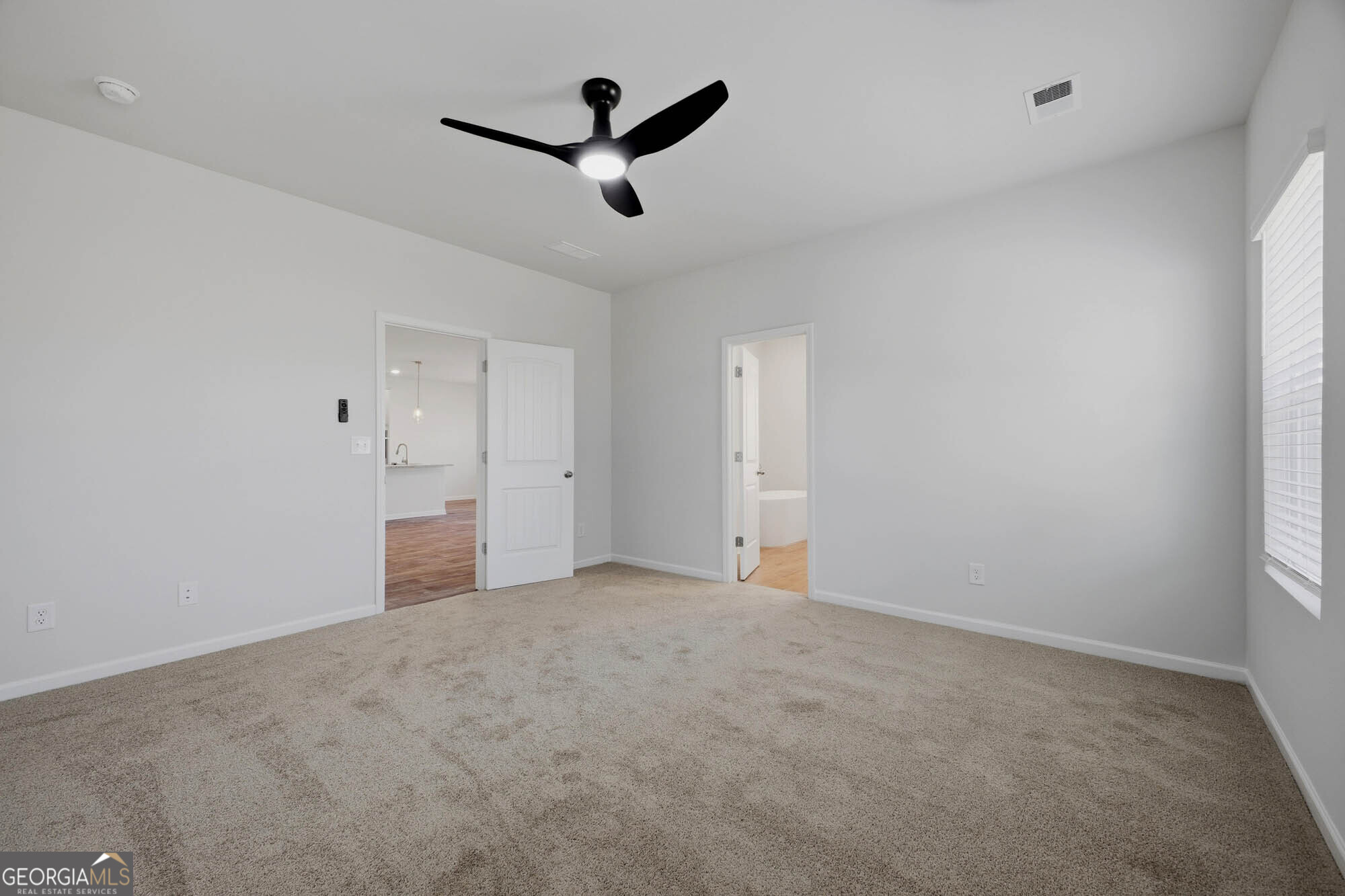 309 Rusty Plow Lane Perry, GA 31069 - Photo 4 of 34 an empty room with ceiling fan and window