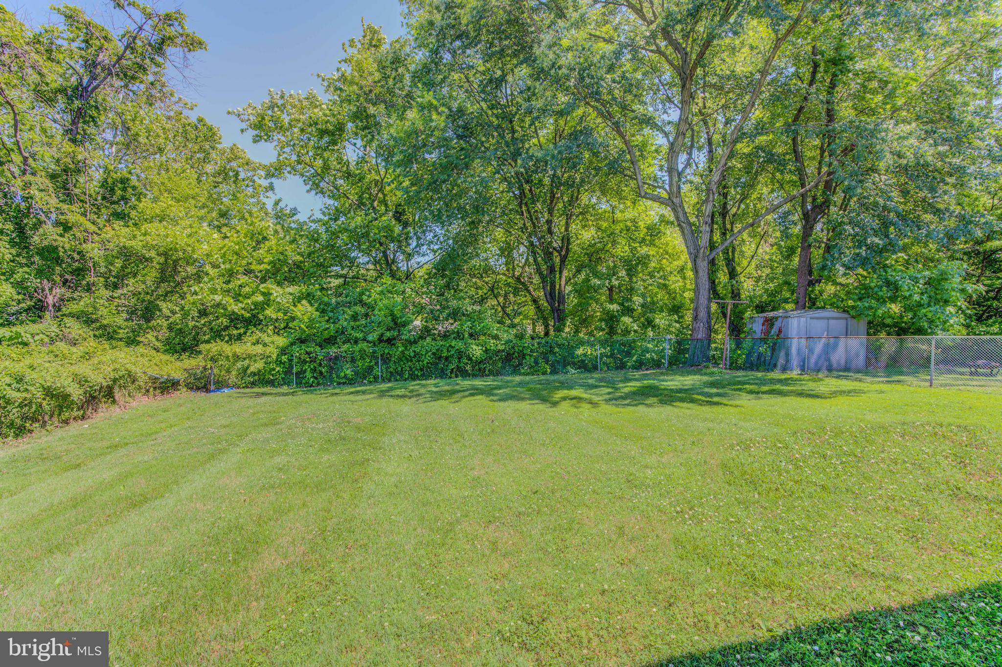 8065 Woodhaven Road Baltimore, MD 21237 - Photo 35 of 35 Large Fenced Rear Yard with Creek