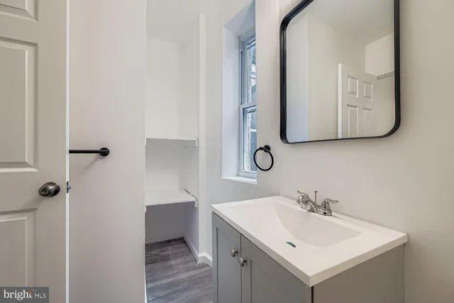 a bathroom with a sink and a mirror