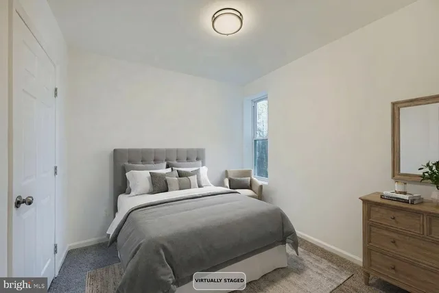 a bedroom with a bed and a dresser