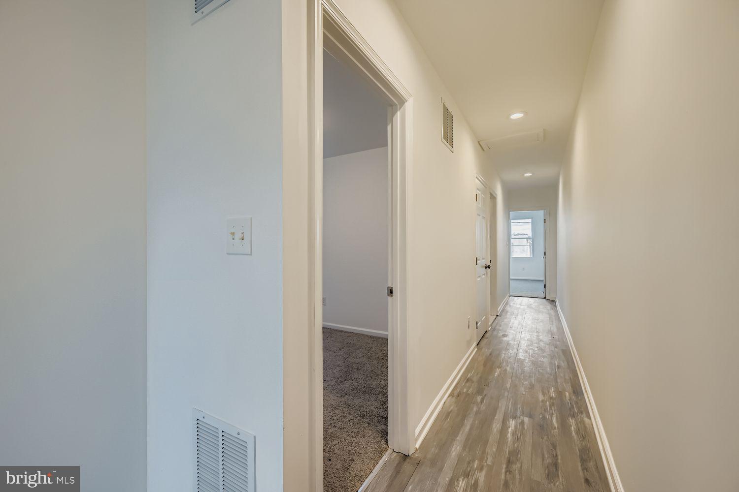 1006 East 20th Street Baltimore, MD 21218 - Photo 20 of 29 a view of a hallway with wooden floor