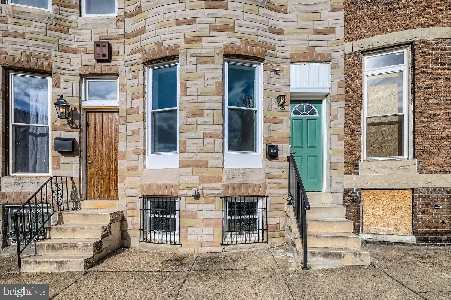 1006 East 20th Street Baltimore, MD 21218 - Photo 2 of 29 a front view of a building with a bench