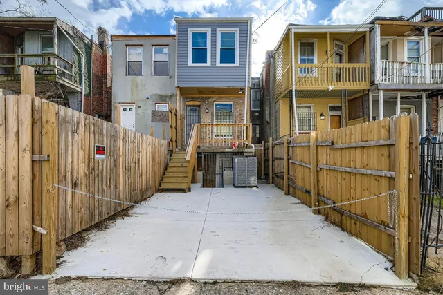 a view of a brick house with many windows