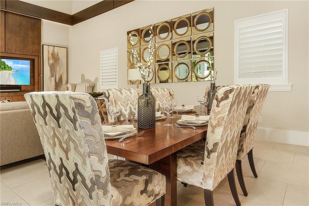 9149 Mercato Way Naples, FL 34108 - Photo 14 of 47 a view of a dining room with furniture and wooden floor