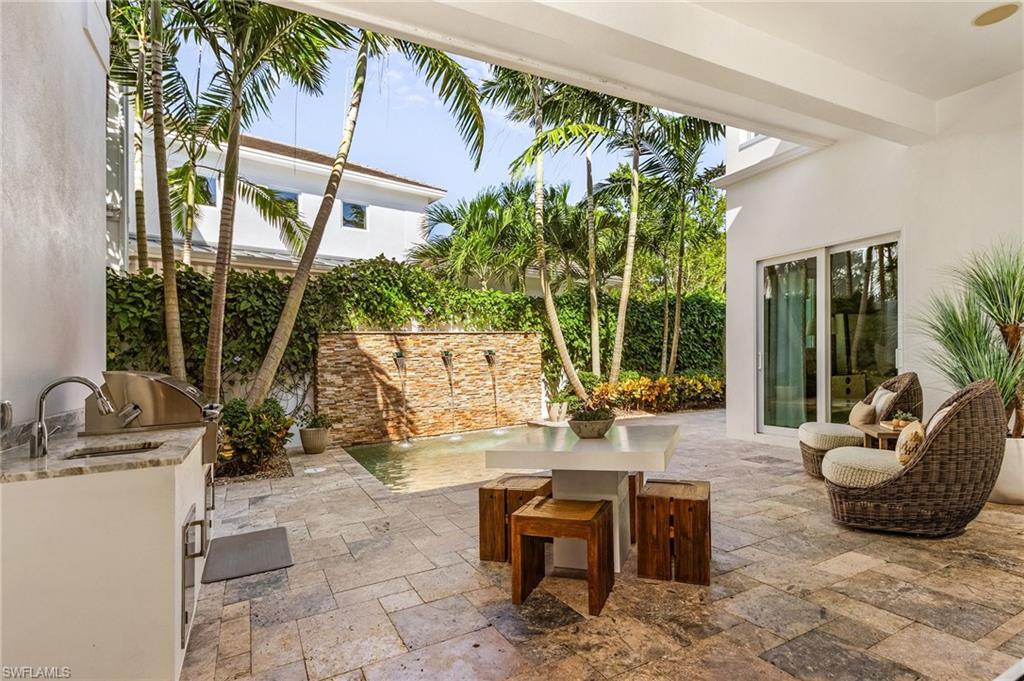 9149 Mercato Way Naples, FL 34108 - Photo 17 of 47 a living room with patio furniture and a potted plant
