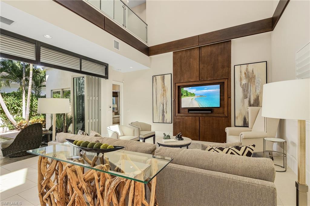 9149 Mercato Way Naples, FL 34108 - Photo 18 of 47 a living room with furniture and a flat screen tv
