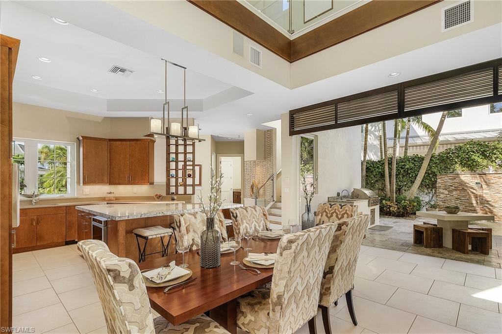 9149 Mercato Way Naples, FL 34108 - Photo 19 of 47 a view of a dining room with furniture and window