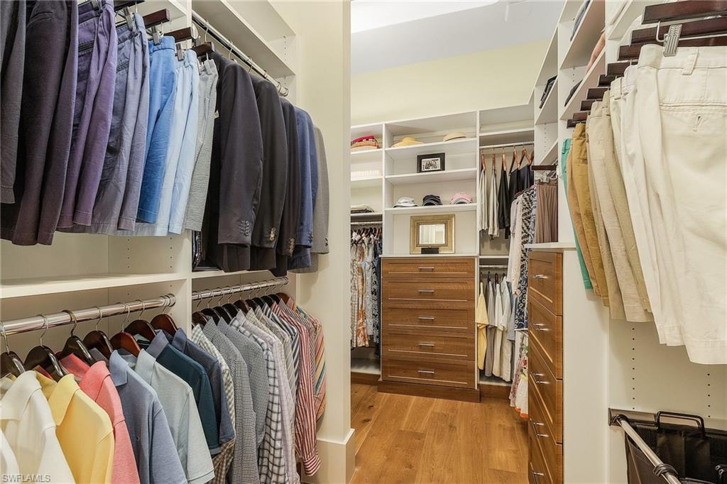 9149 Mercato Way Naples, FL 34108 - Photo 23 of 47 a view of walk in closet with clothes and shoes
