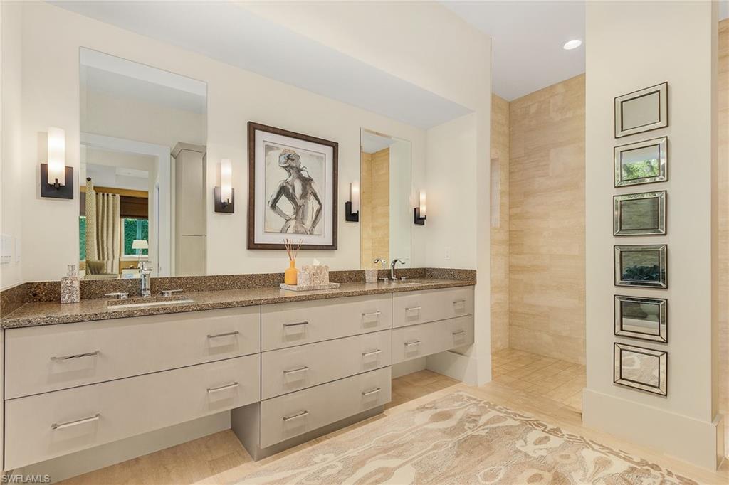 9149 Mercato Way Naples, FL 34108 - Photo 24 of 47 a bathroom with a granite countertop double vanity sink a mirror and a