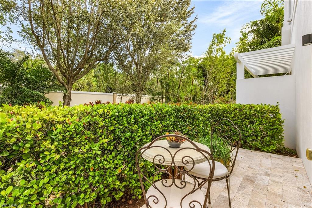 9149 Mercato Way Naples, FL 34108 - Photo 27 of 47 a backyard of a house with table and chairs