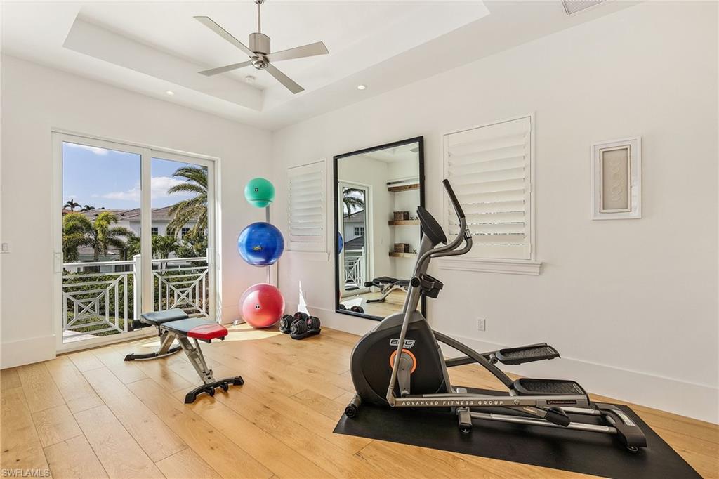 9149 Mercato Way Naples, FL 34108 - Photo 32 of 47 a room with gym equipment and view of living room