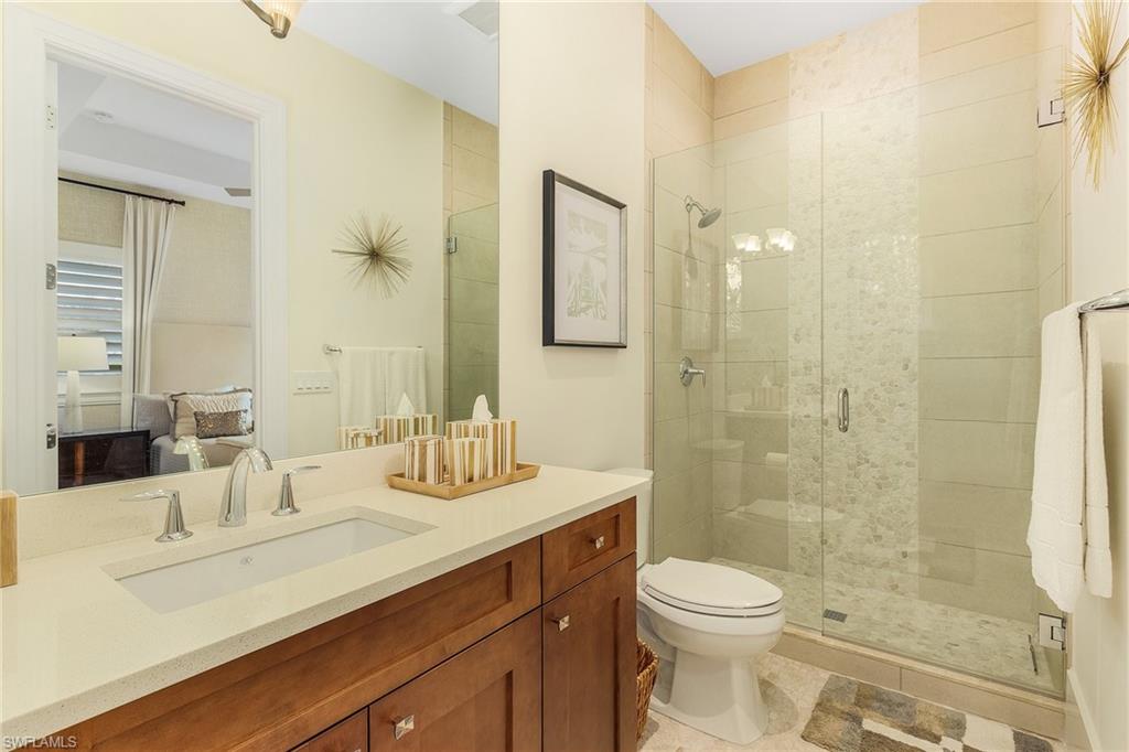 9149 Mercato Way Naples, FL 34108 - Photo 35 of 47 a bathroom with a sink a toilet and shower