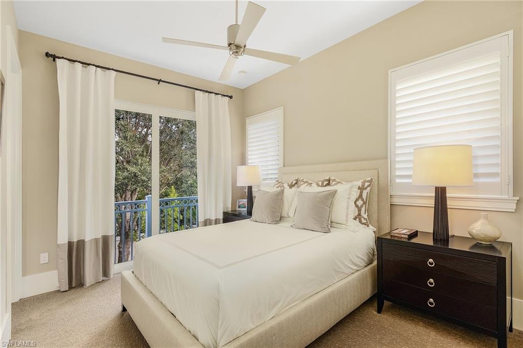 9149 Mercato Way Naples, FL 34108 - Photo 37 of 47 a large bed sitting in a bedroom next to a window
