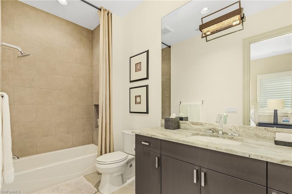 9149 Mercato Way Naples, FL 34108 - Photo 38 of 47 a bathroom with a granite countertop sink toilet and shower