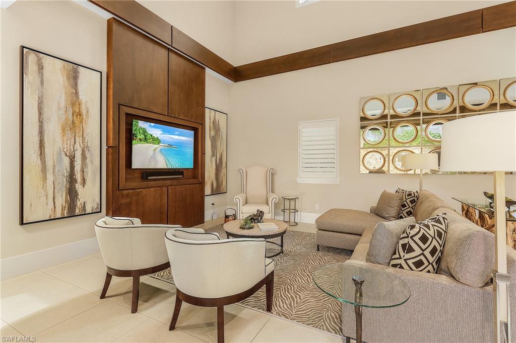 9149 Mercato Way Naples, FL 34108 - Photo 40 of 47 a living room with furniture and a flat screen tv