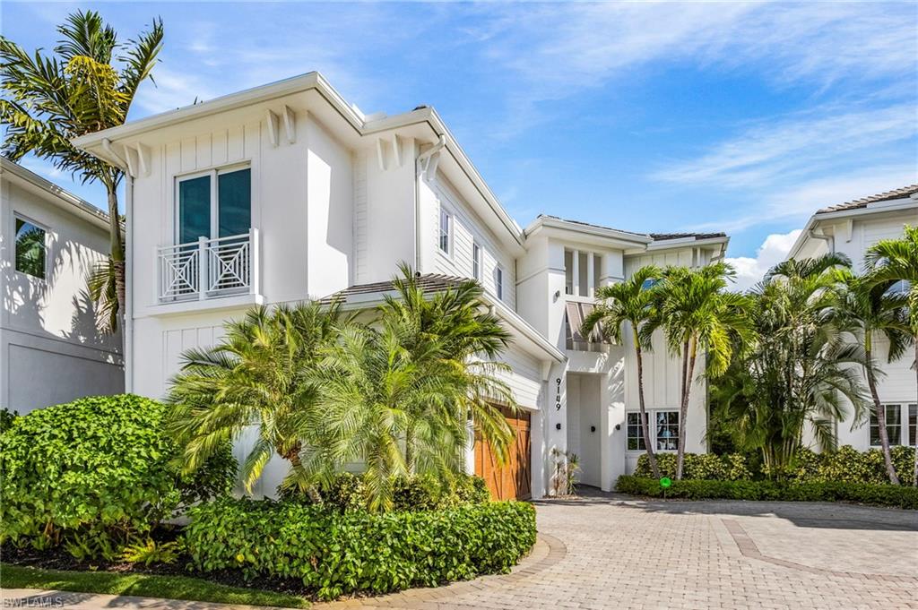 9149 Mercato Way Naples, FL 34108 - Photo 4 of 47 a front view of a house with a yard