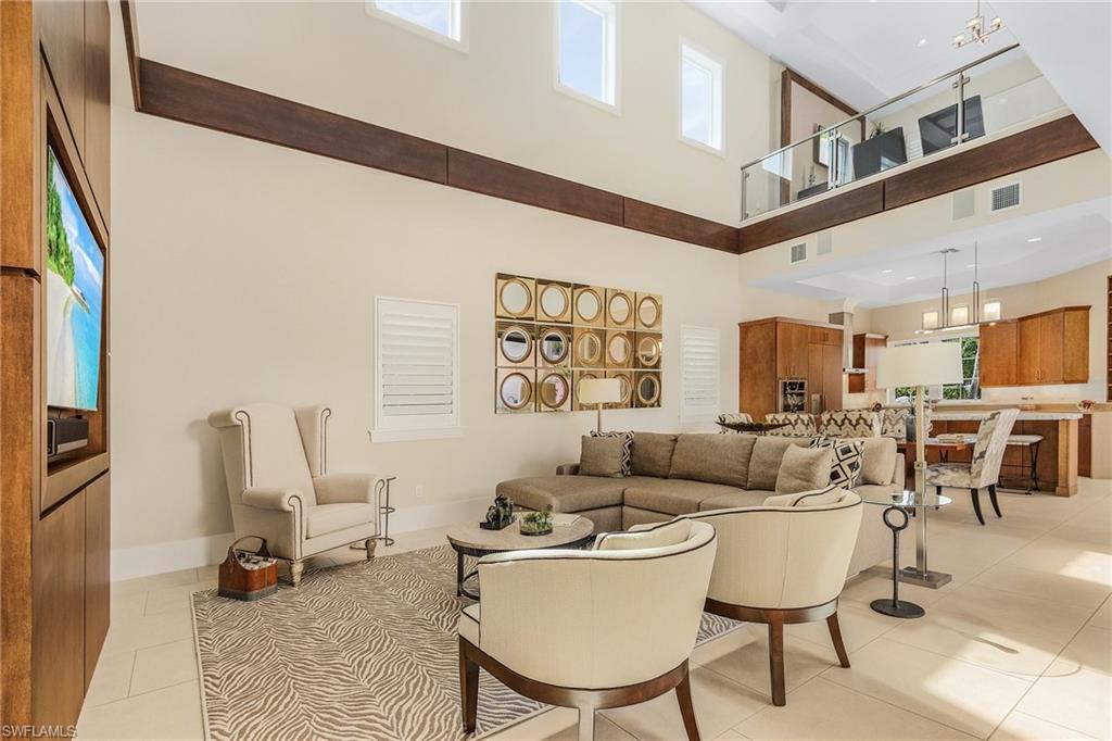 9149 Mercato Way Naples, FL 34108 - Photo 41 of 47 a living room with furniture a rug and a large window