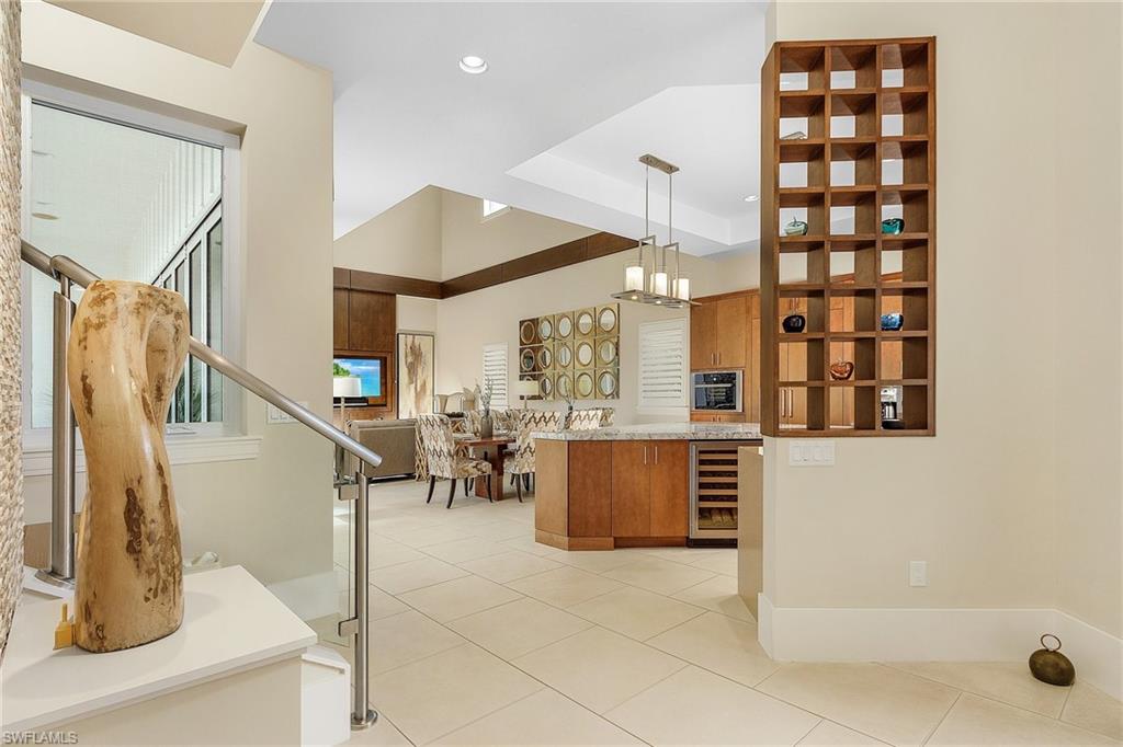 9149 Mercato Way Naples, FL 34108 - Photo 6 of 47 a kitchen with stainless steel appliances kitchen island granite countertop a refrigerator and a sink