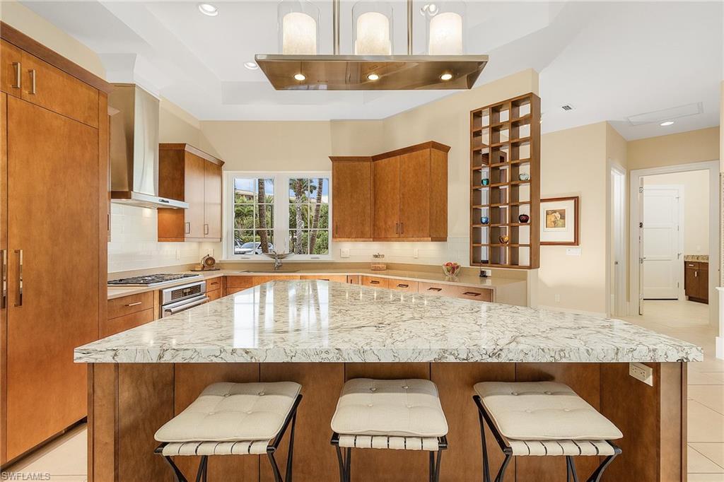 9149 Mercato Way Naples, FL 34108 - Photo 10 of 47 a kitchen with a stove a sink and a refrigerator