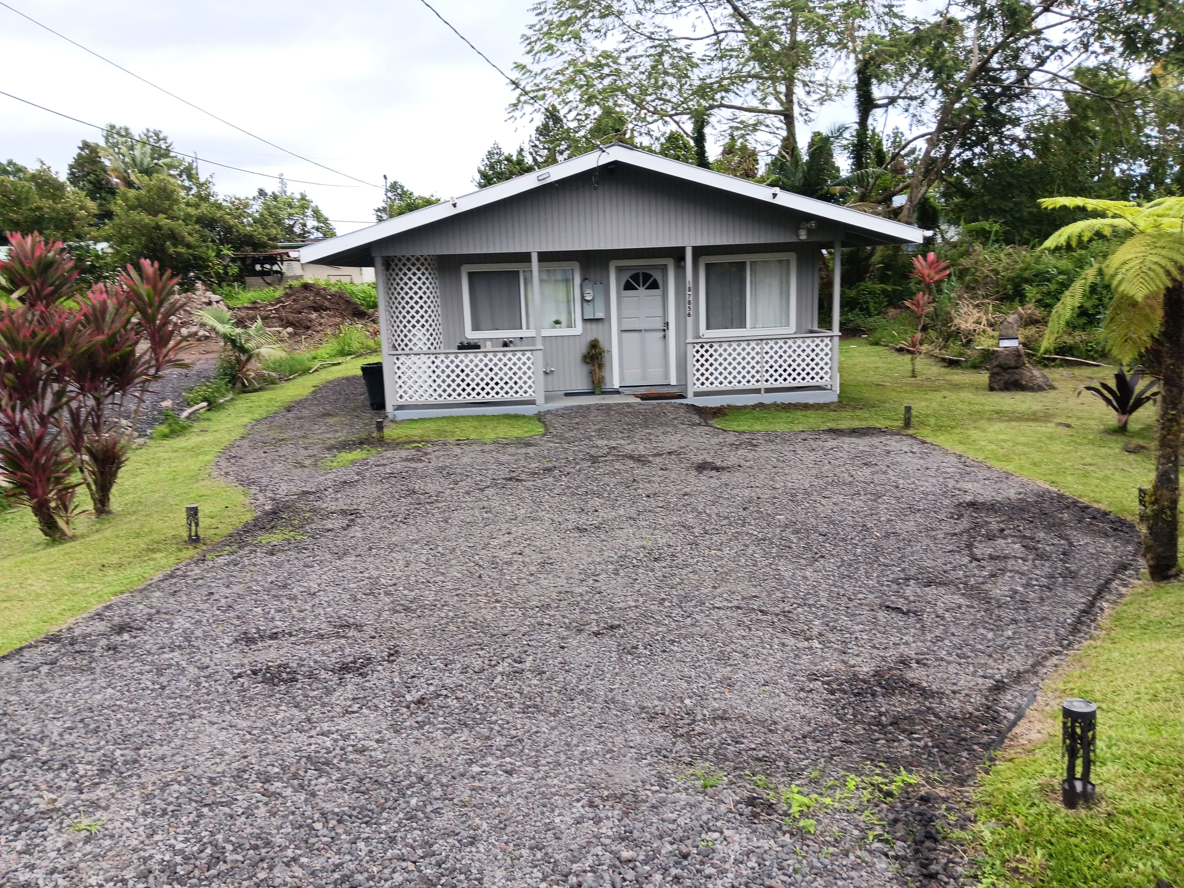 18-7856 Ekika Road Mountain View, HI 96771 - Photo 1 of 7 a front view of a house with garden