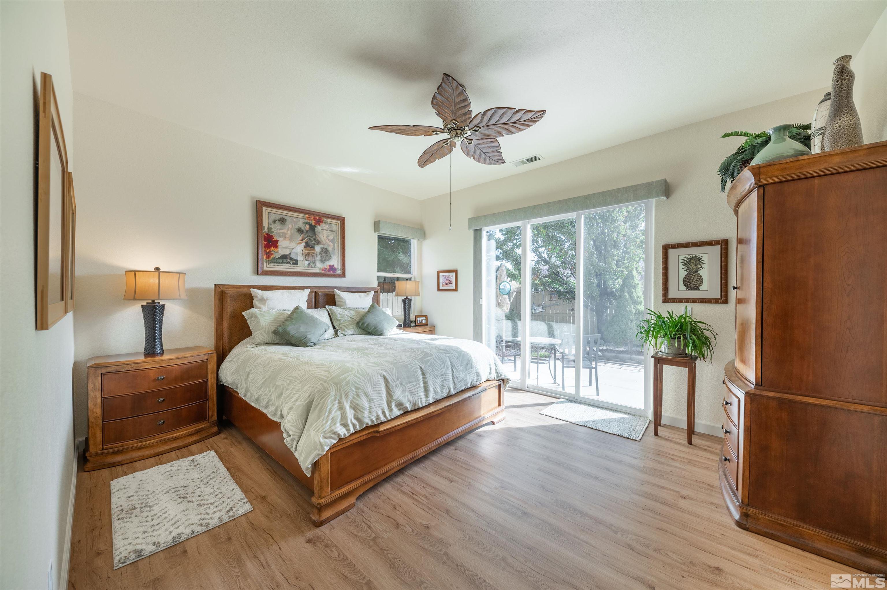 10518 Crystal Bay Drive Reno, NV 89521 - Photo 16 of 39 a spacious bedroom with a bed and wooden floor