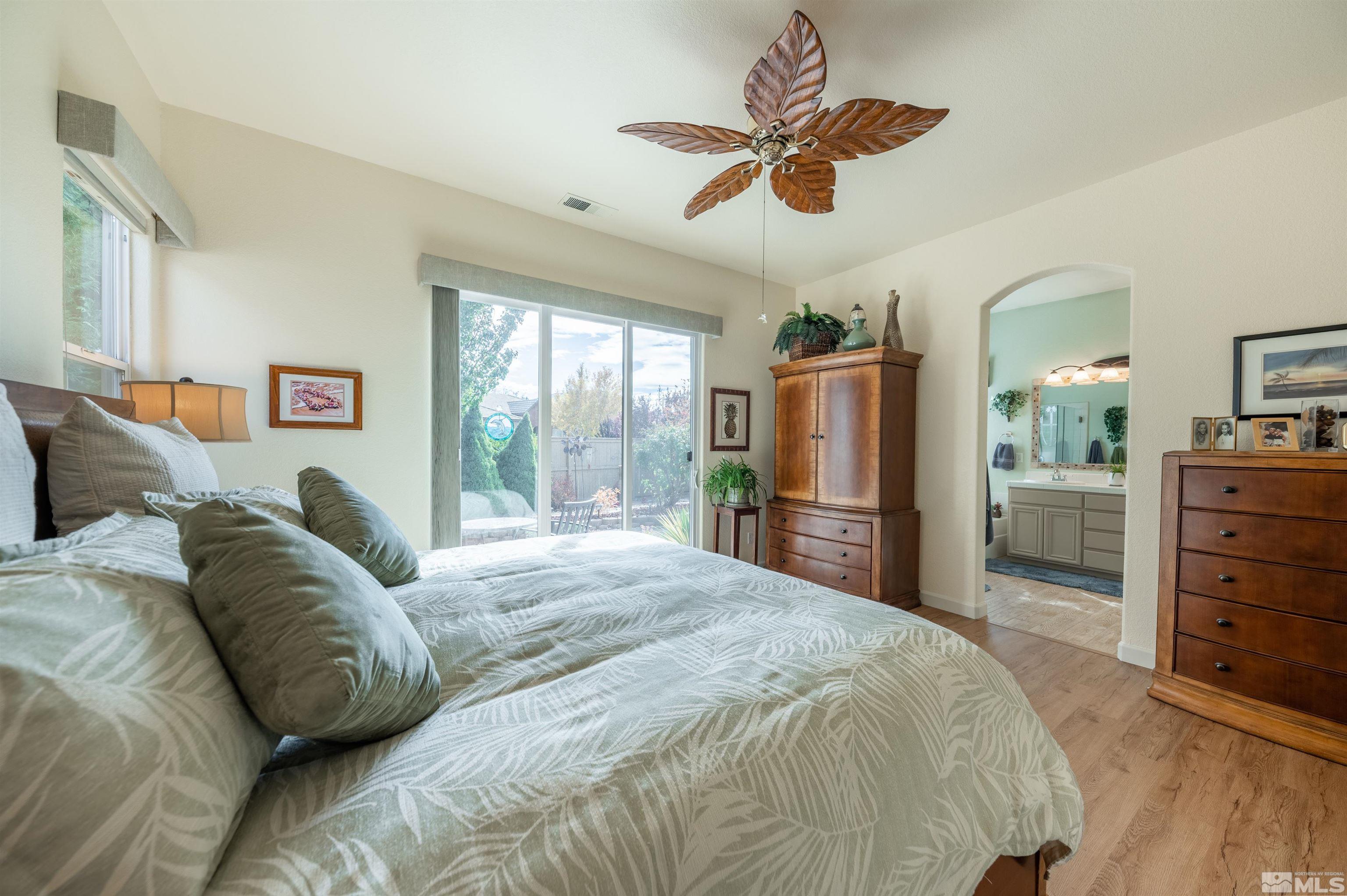 10518 Crystal Bay Drive Reno, NV 89521 - Photo 17 of 39 a spacious bedroom with a bed a dresser and a chandelier