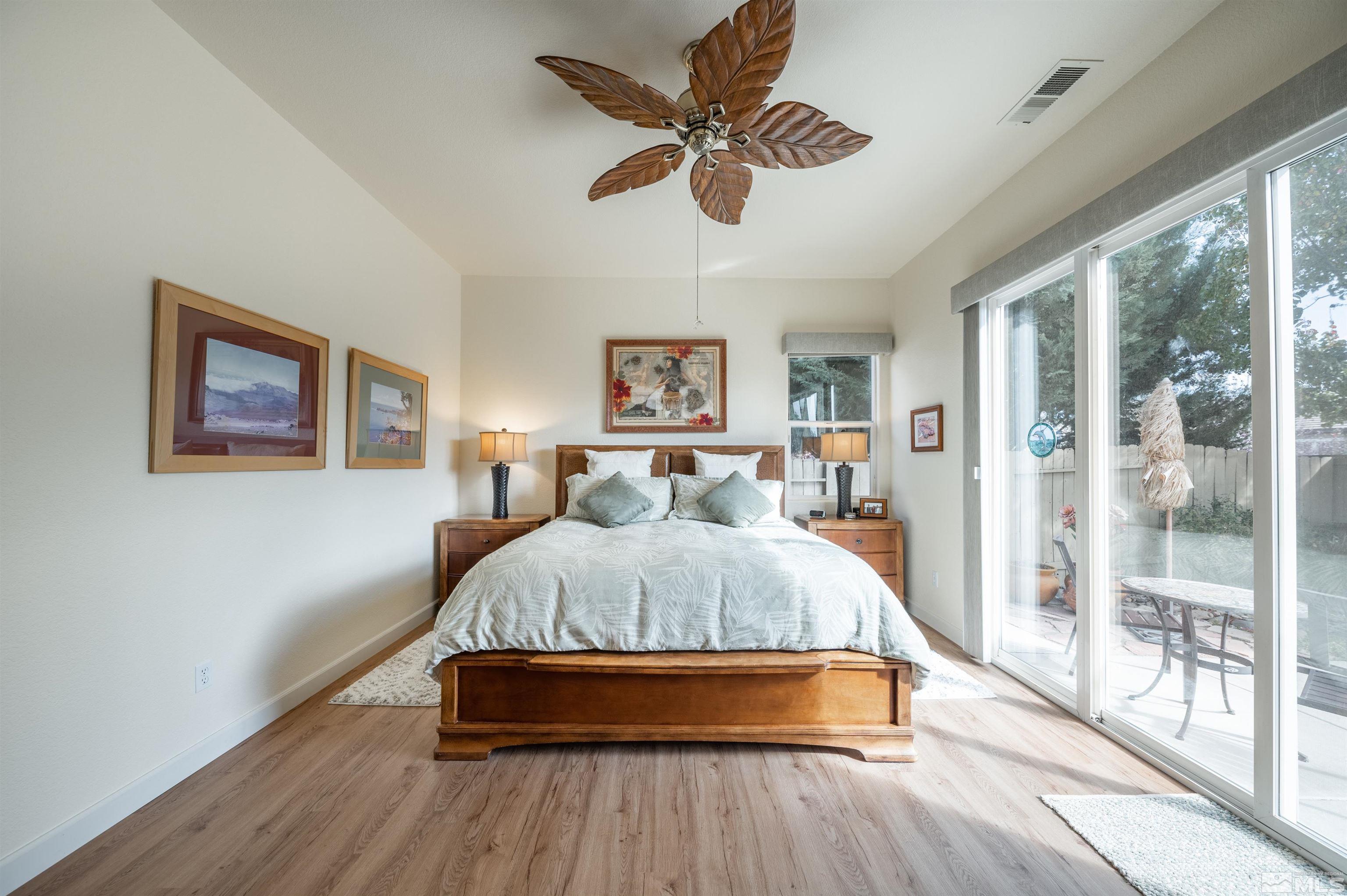 10518 Crystal Bay Drive Reno, NV 89521 - Photo 18 of 39 a spacious bedroom with a bed and glass door