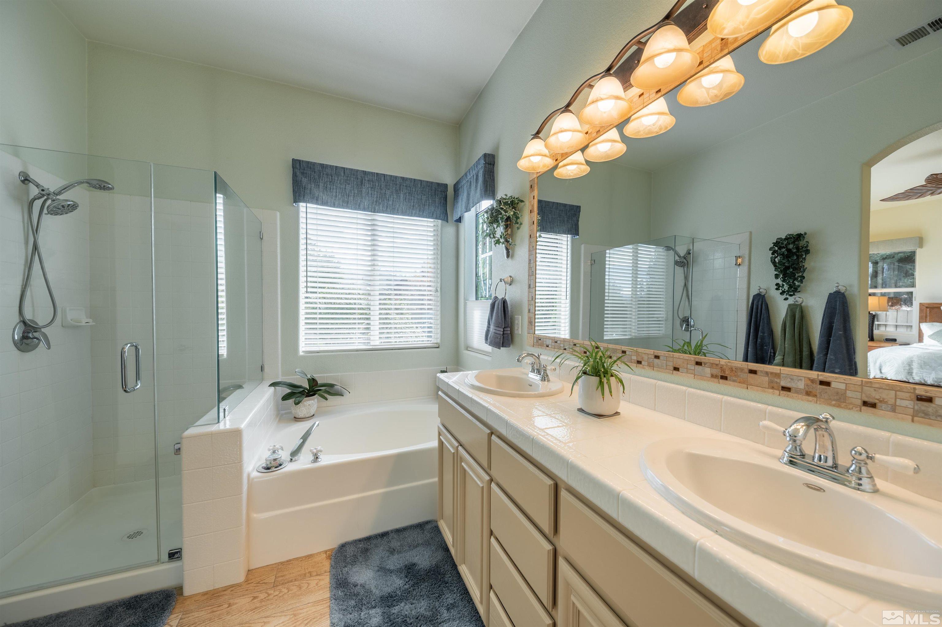10518 Crystal Bay Drive Reno, NV 89521 - Photo 19 of 39 a bathroom with a tub double sink window and mirror