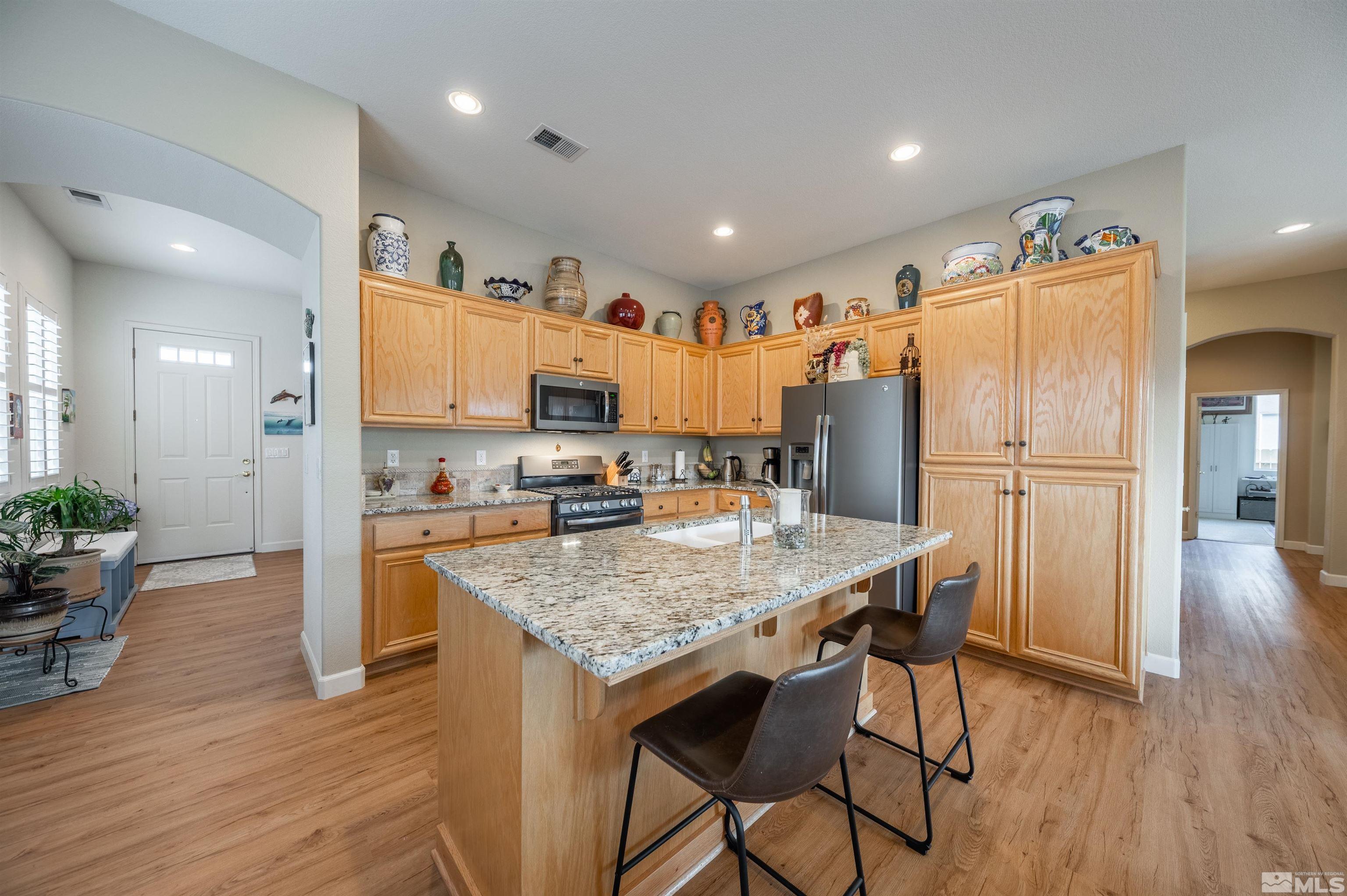 10518 Crystal Bay Drive Reno, NV 89521 - Photo 4 of 39 a kitchen with granite countertop a refrigerator and a sink