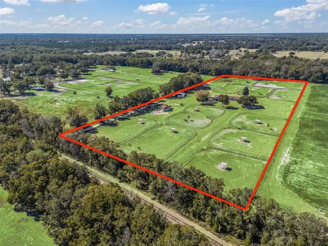 an aerial view of a house with outdoor space swimming pool
