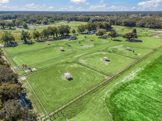 an aerial view of a house with a yard basket ball court and outdoor seating