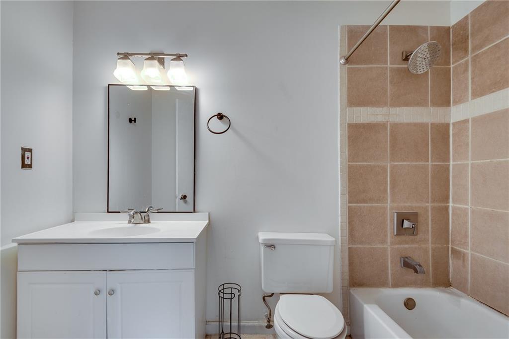 5611 Whittondale Road Lithonia, GA 30058 - Photo 20 of 34 a bathroom with a sink toilet and shower