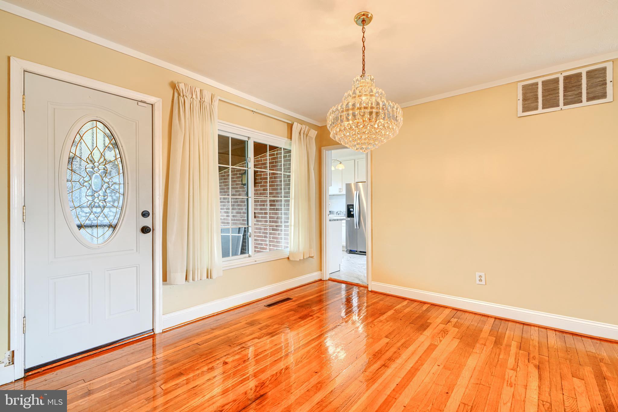 930 Sedgley Road Baltimore, MD 21228 - Photo 11 of 43 a view of an empty room with wooden floor and a window