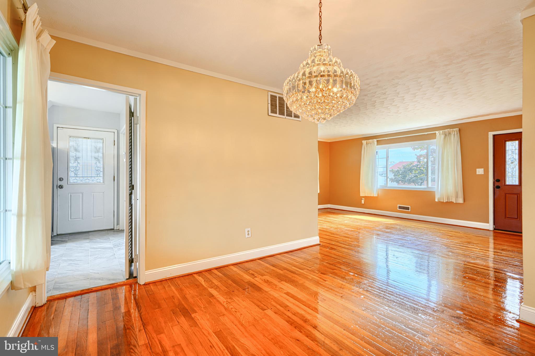 930 Sedgley Road Baltimore, MD 21228 - Photo 12 of 43 a view of an empty room with wooden floor and a window