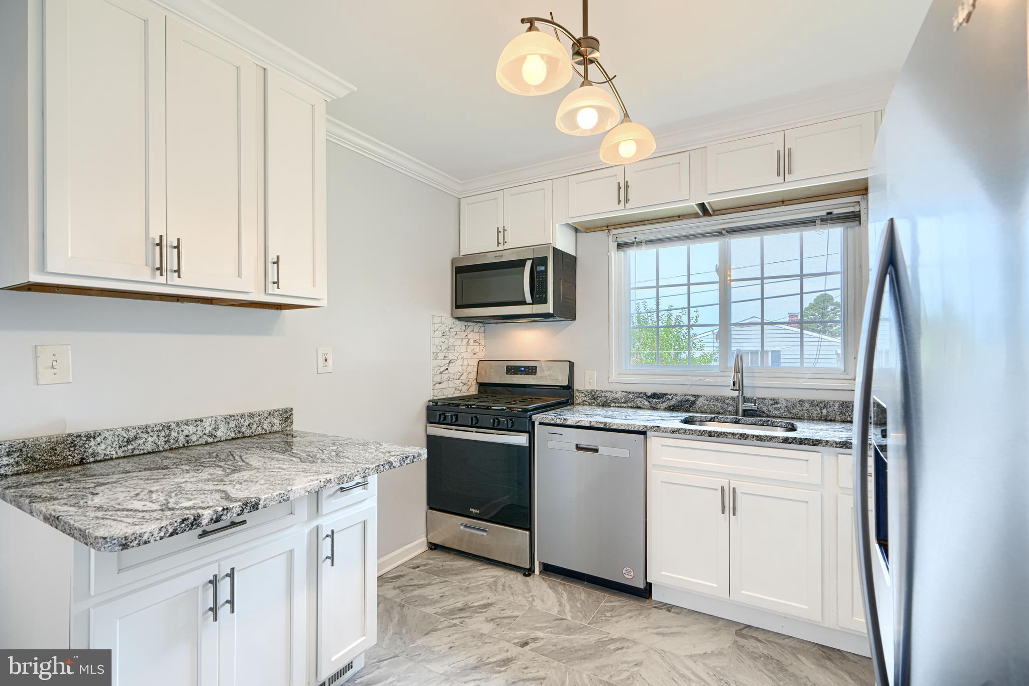 930 Sedgley Road Baltimore, MD 21228 - Photo 14 of 43 a kitchen with stainless steel appliances granite countertop a stove and a sink
