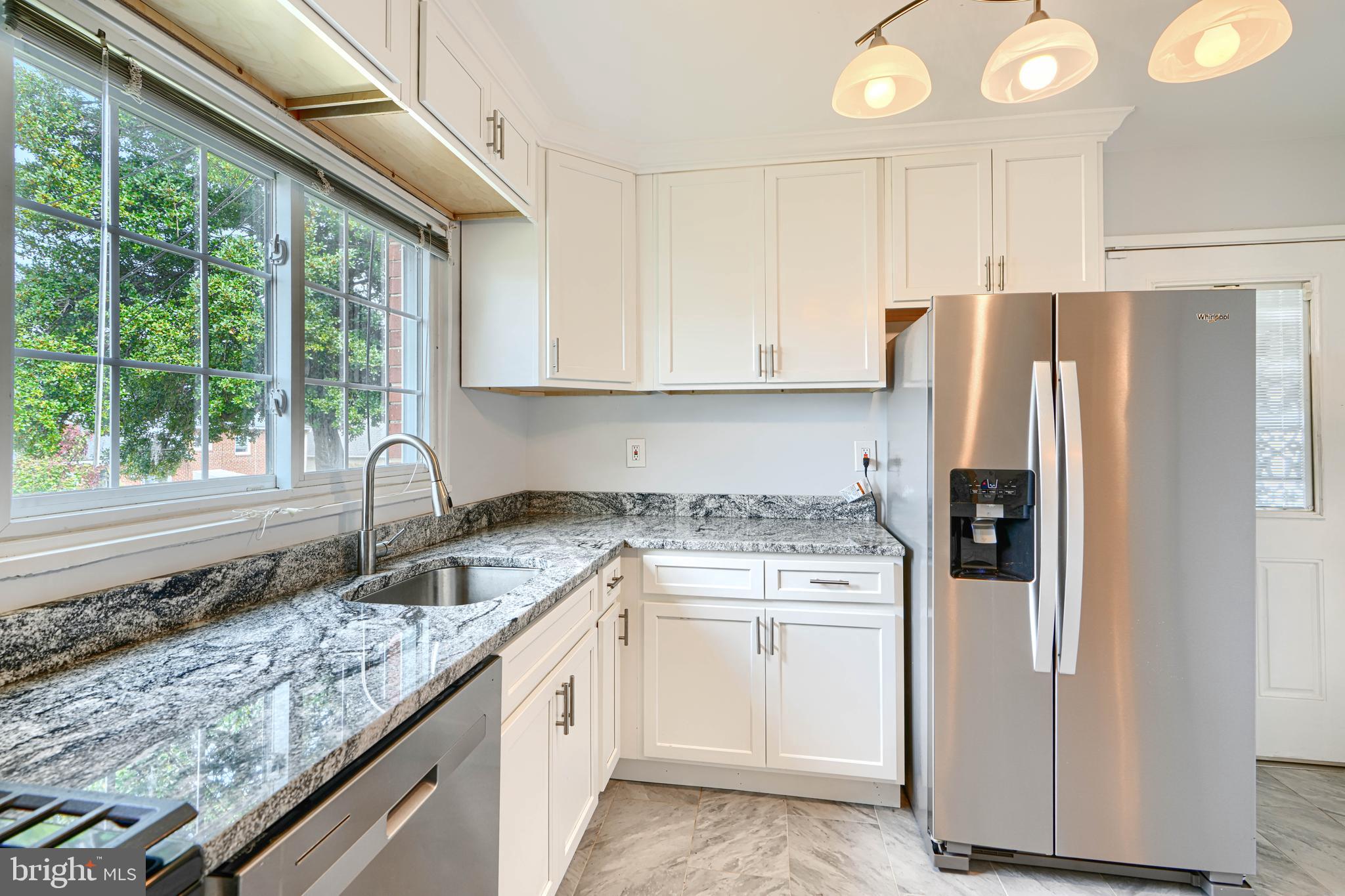 930 Sedgley Road Baltimore, MD 21228 - Photo 17 of 43 a kitchen with a sink stove and refrigerator