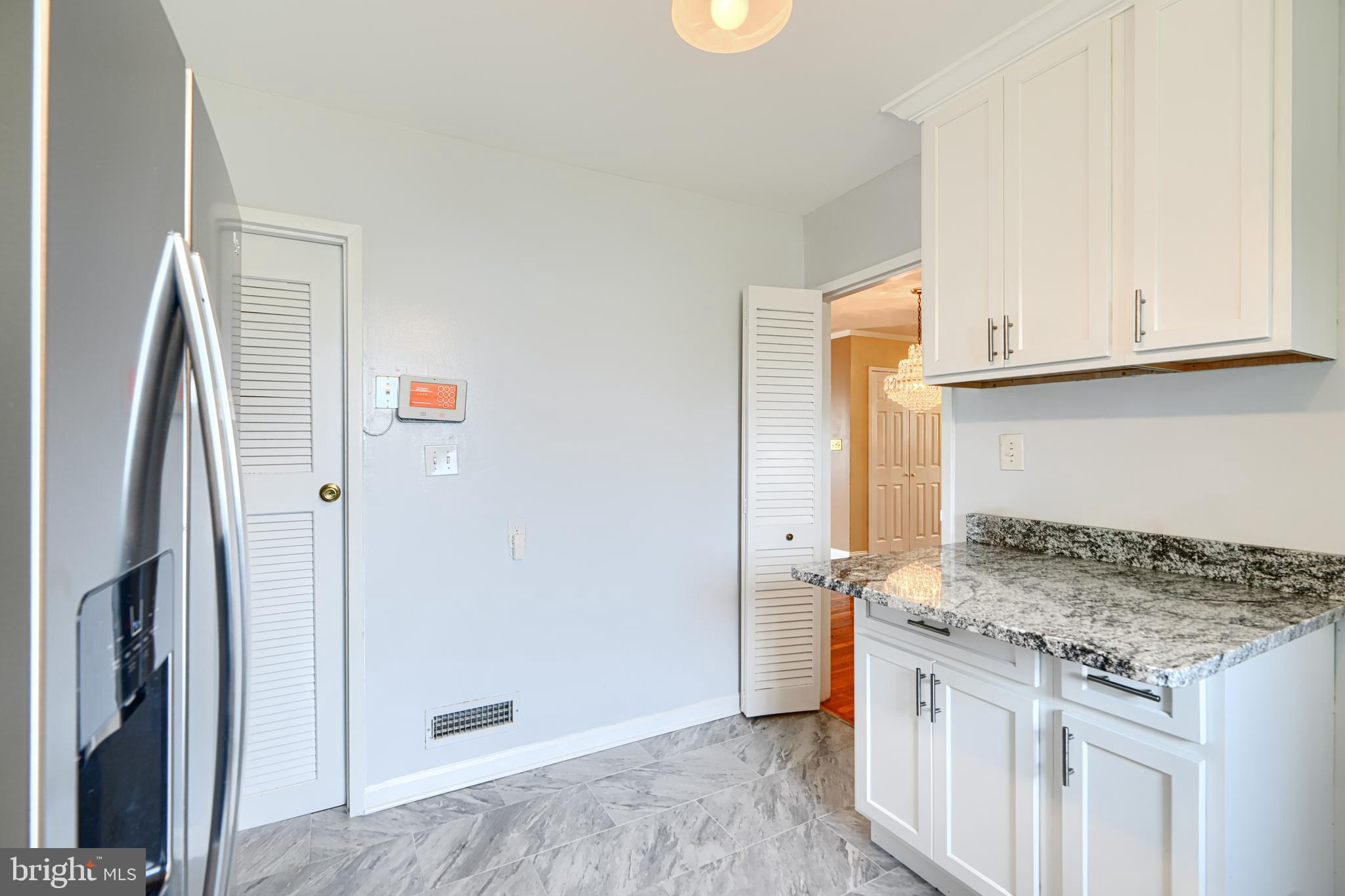 930 Sedgley Road Baltimore, MD 21228 - Photo 18 of 43 a kitchen with granite countertop a sink stove and refrigerator
