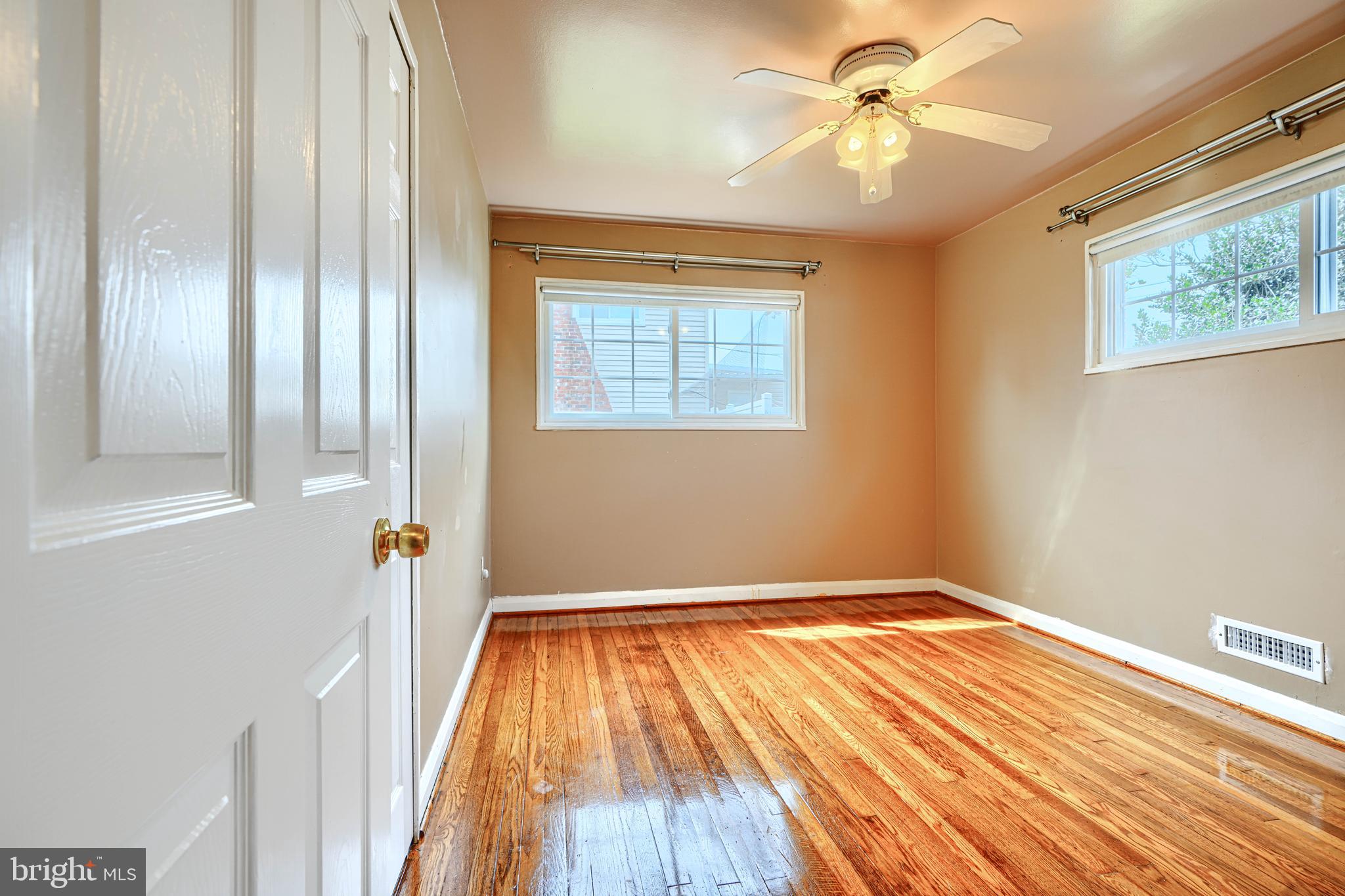 930 Sedgley Road Baltimore, MD 21228 - Photo 21 of 43 wooden floor in an empty room with a window