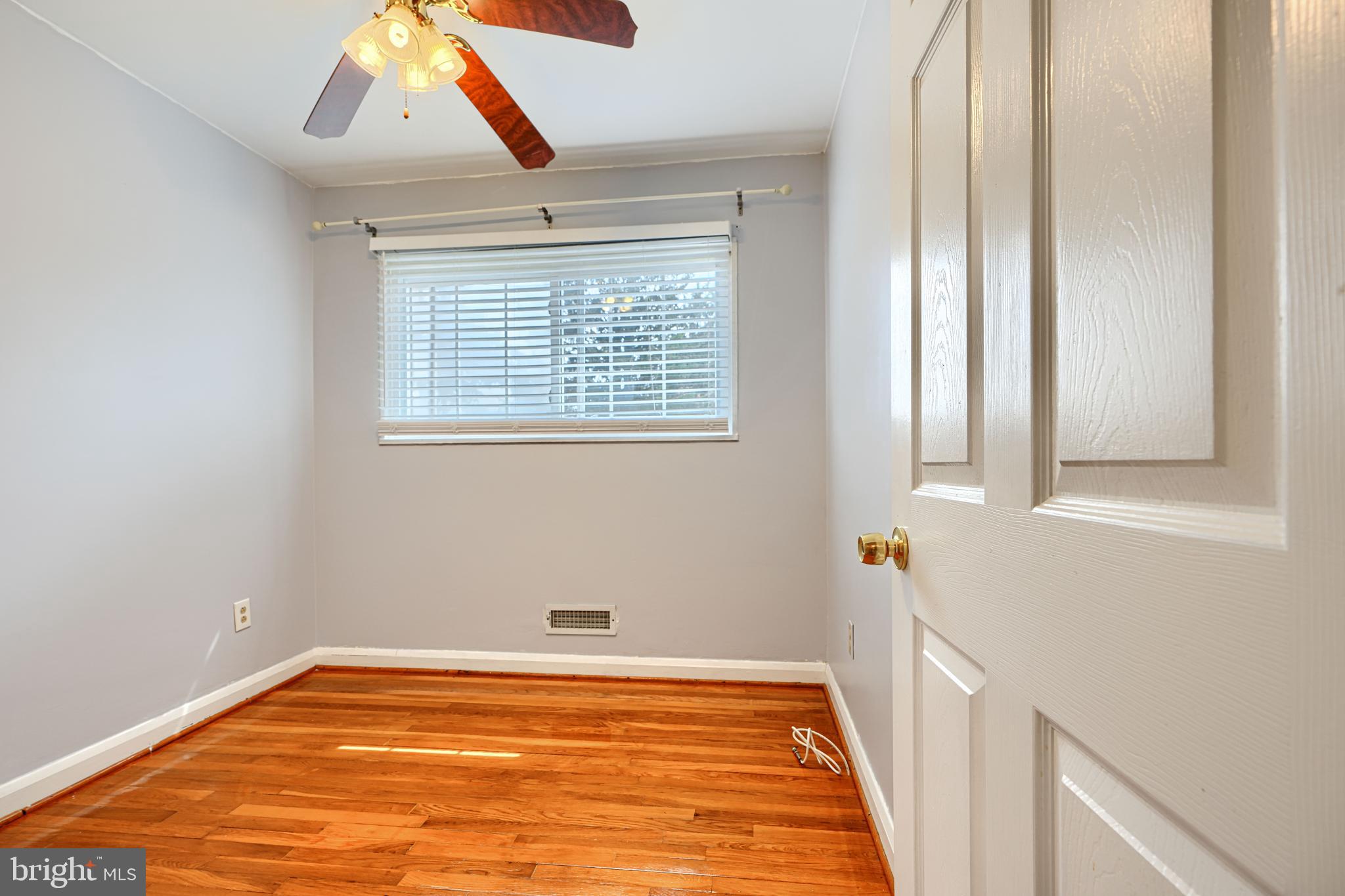 930 Sedgley Road Baltimore, MD 21228 - Photo 25 of 43 a view of an empty room with wooden floor and a window