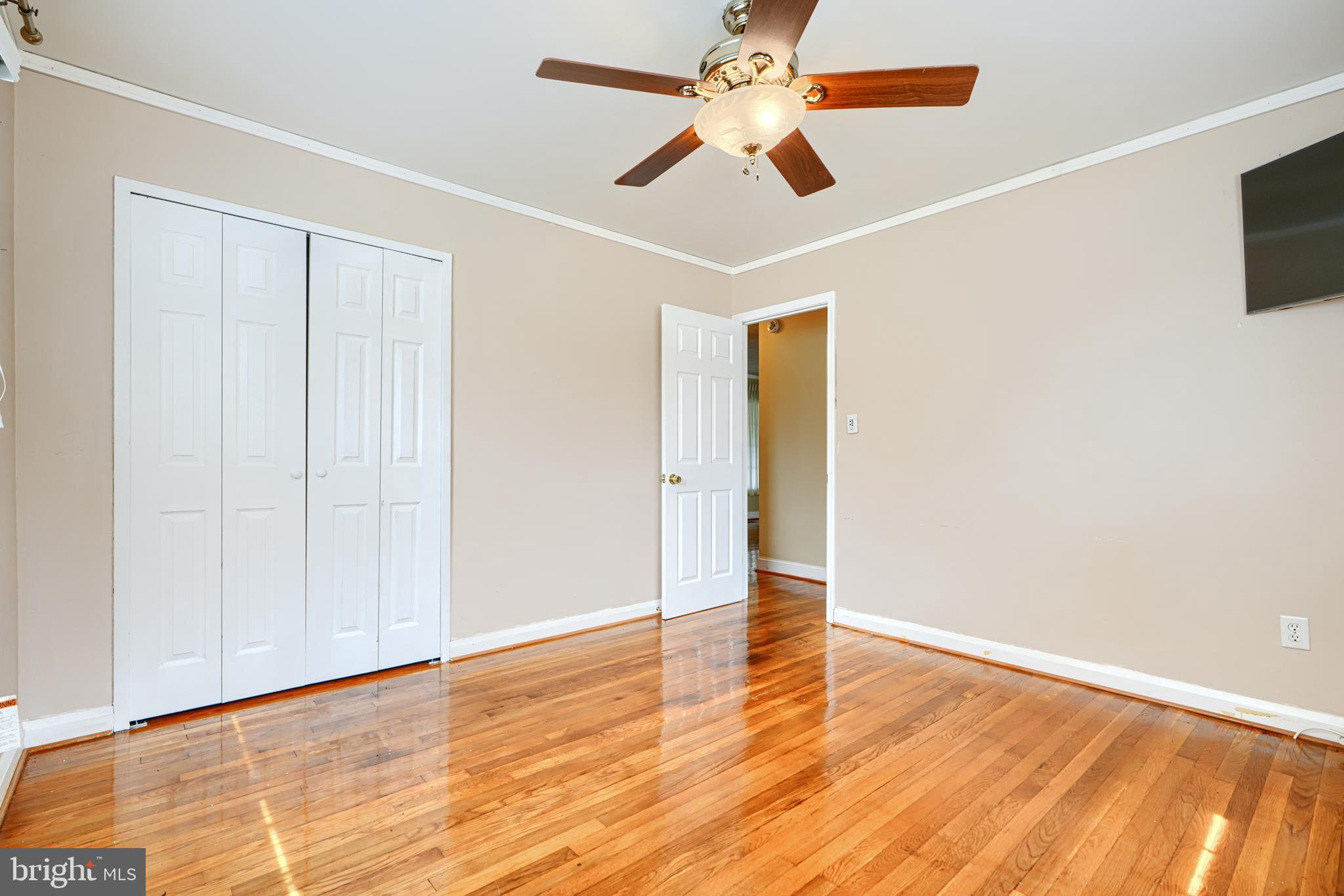 930 Sedgley Road Baltimore, MD 21228 - Photo 31 of 43 an empty room with wooden floor and windows